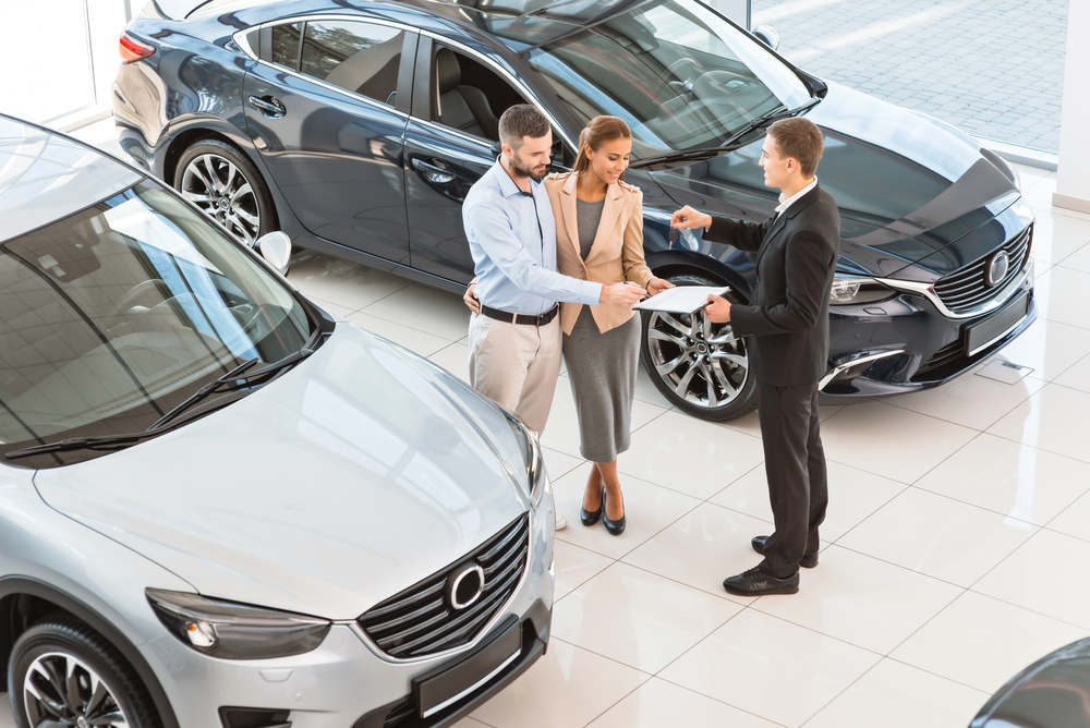 choosing and buying new car at showroom.